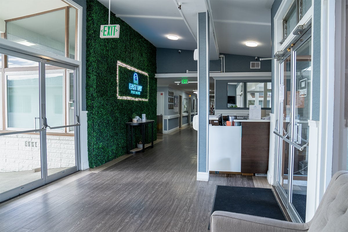 east bay post acute long hall with large windows and tall ceilings