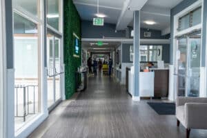 east bay post acute long hall with large windows and tall ceilings