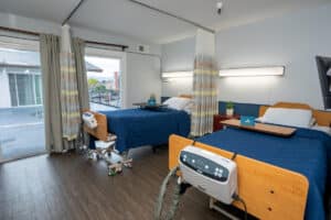 east bay post acute resident room with two large beds and large windows